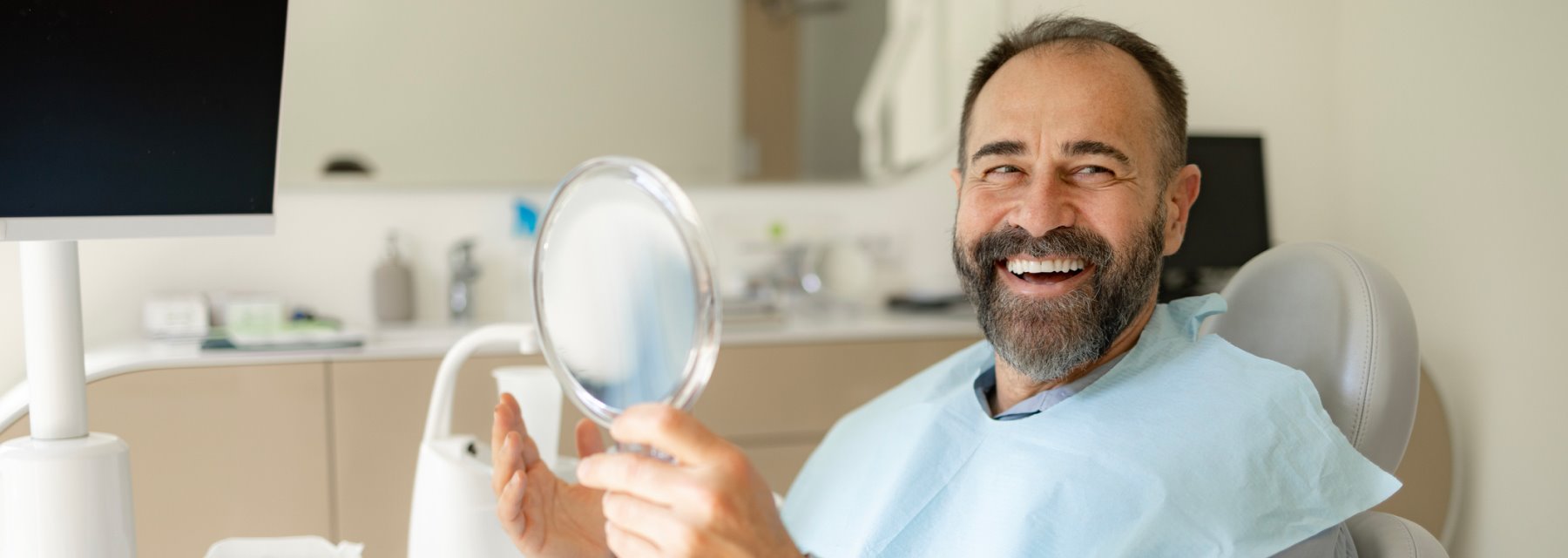 Man Smiles Confidently While Seated In A Dental Chair at Charleston West Virginia