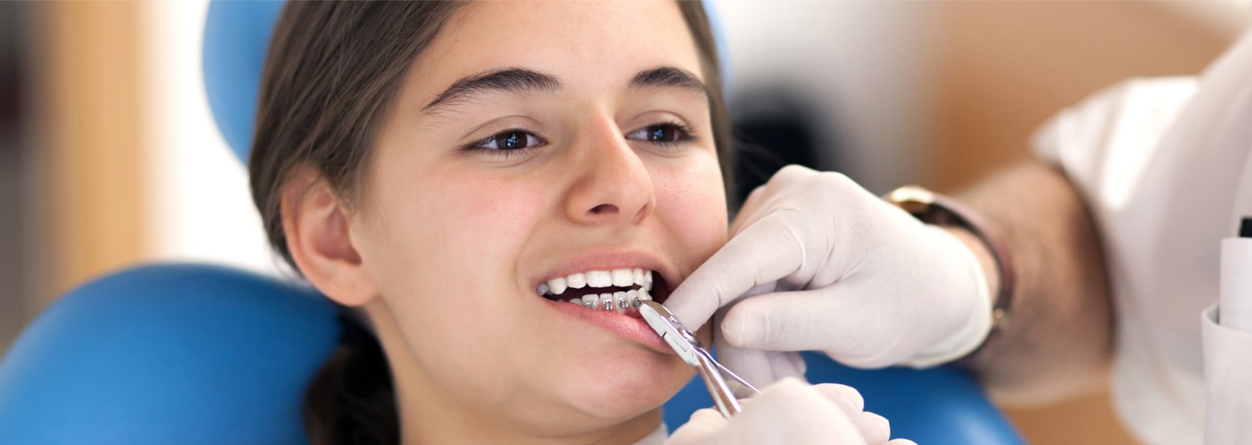 Woman Sits In A Dental Chair As A Dentist Examines Her Teeth at Charleston West Virginia