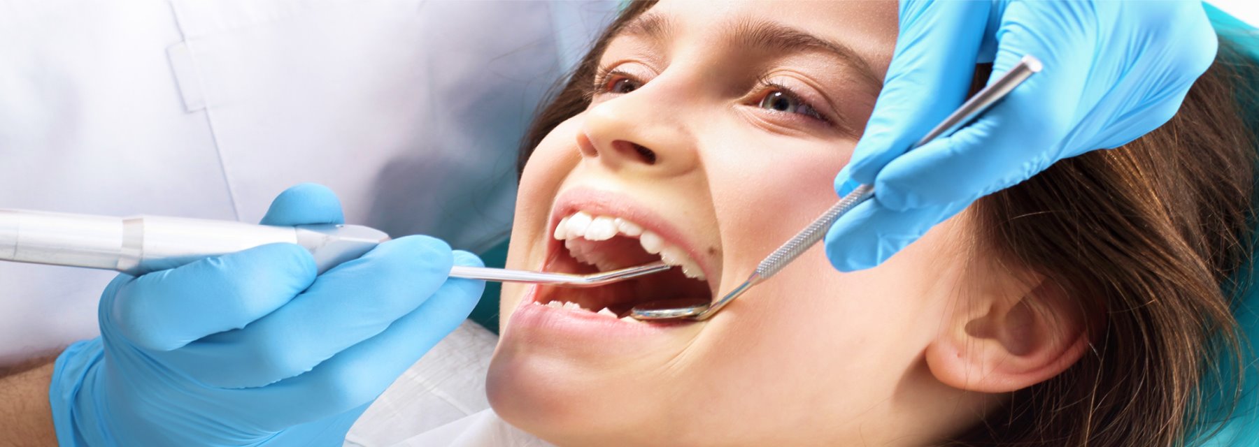 Young Girl Sits In A Dental Chair While A Dentist Examines Her Teeth at Charleston West Virginia