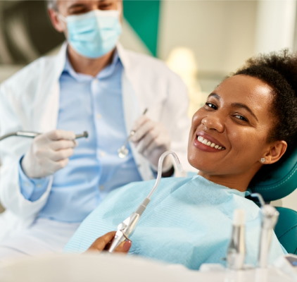 Smiling Woman Sits Comfortably In A Dentist Chair at Charleston West Virginia