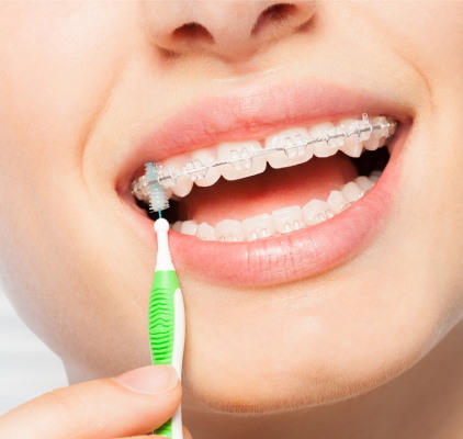 Woman Using An Electric Toothbrush To Brush Her Teeth at Charleston West Virginia